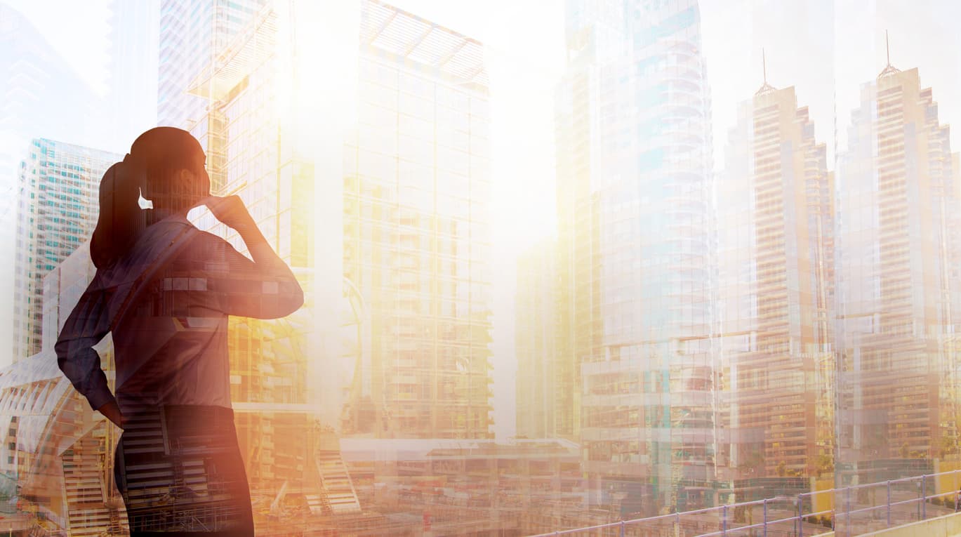 A woman looking out the window contemplating the latest real estate shifts