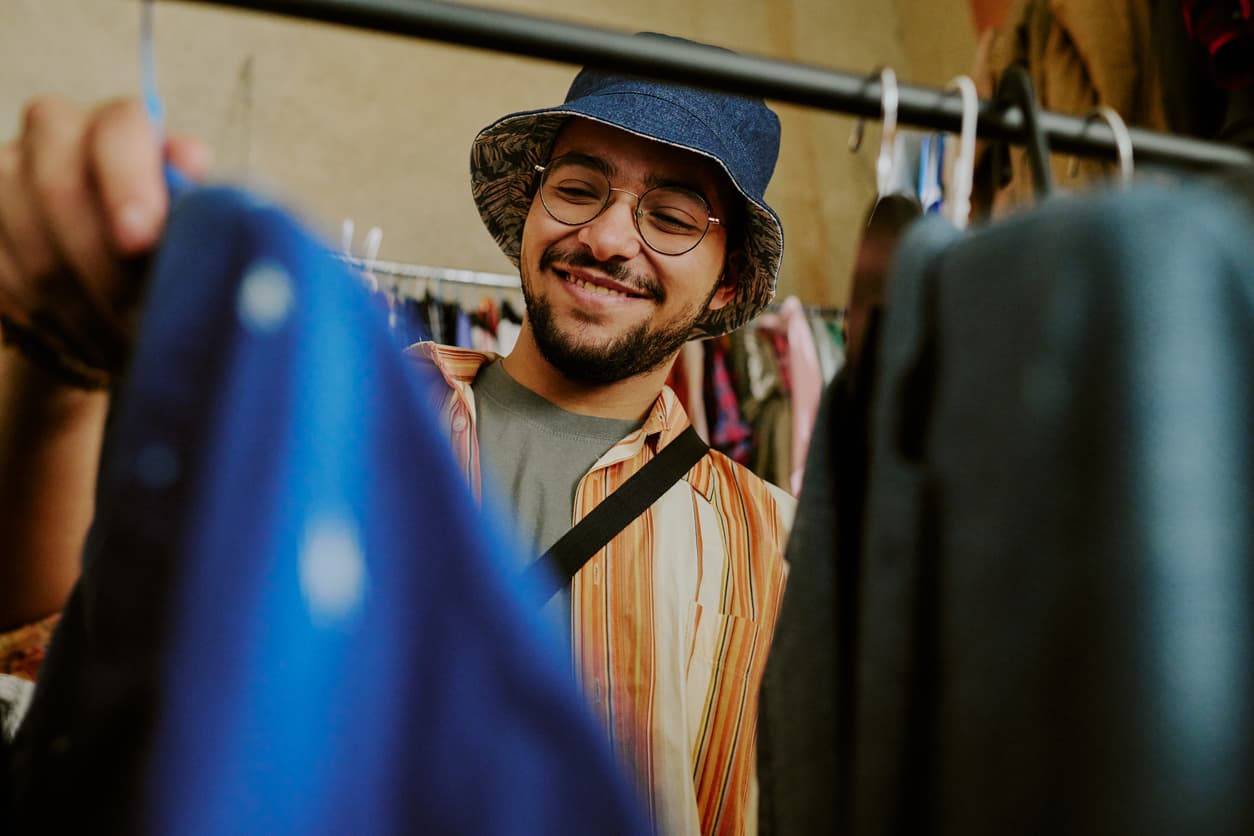 A smiling man shopping at a secondhand market